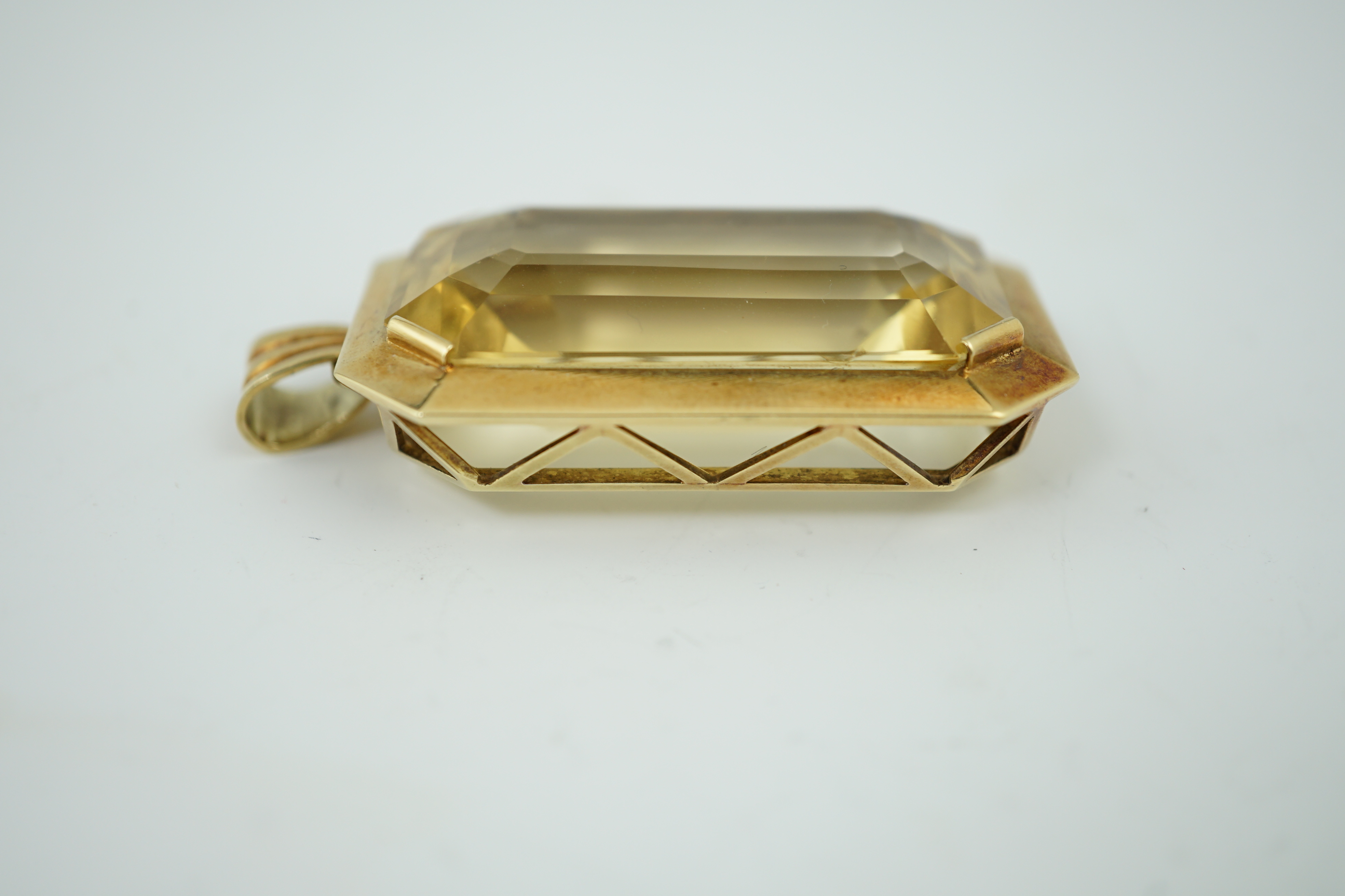 A large mid 20th century 14k gold and emerald cut citrine set pendant